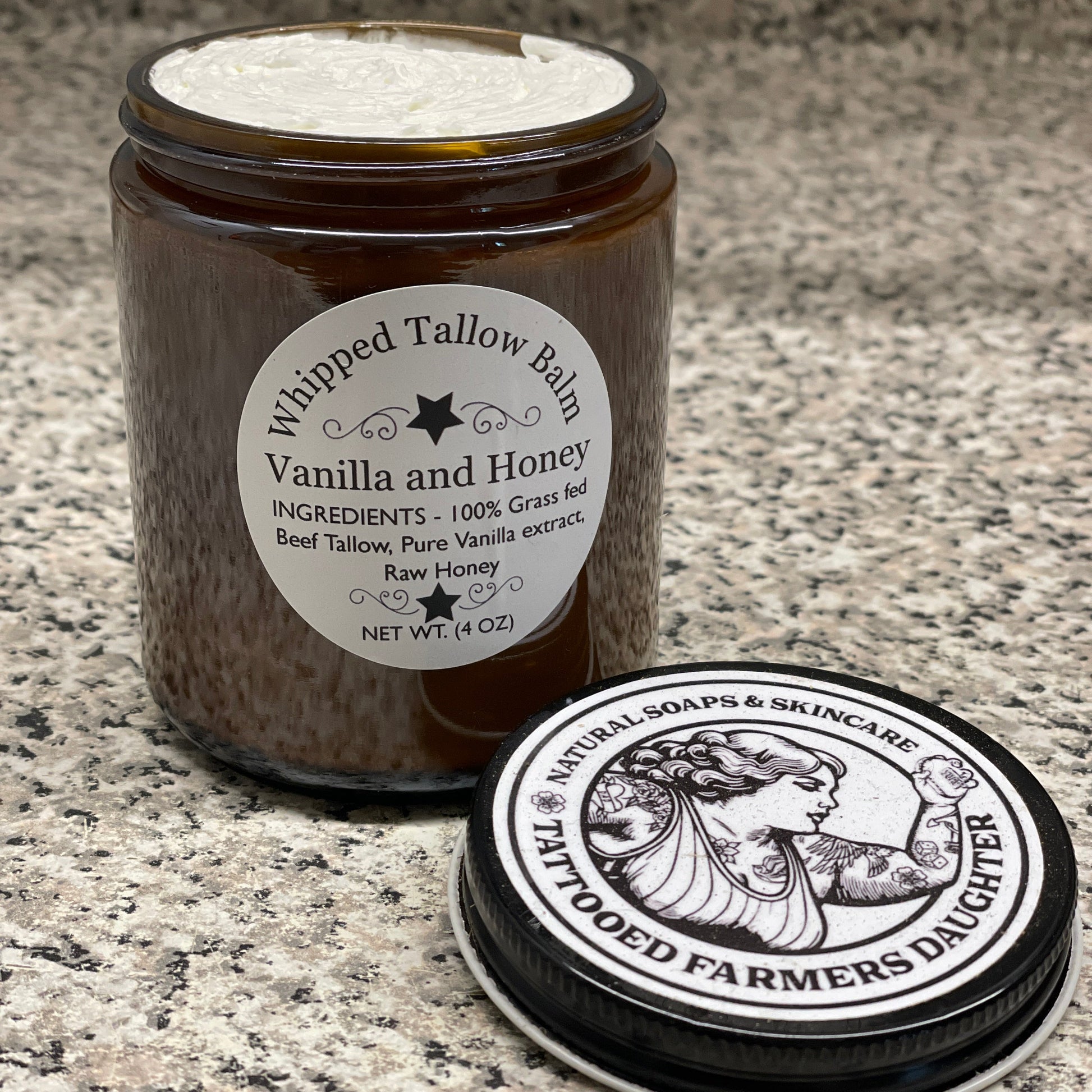 Tallow balm jar with a label on a textured surface