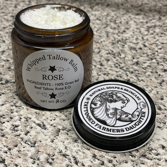 Tallow balm jar with rose scent on a granite surface