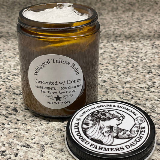 Tallow balm with Tattooed Farmers label on a textured surface